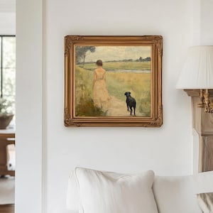 May include: A framed oil painting depicting a woman in a white dress walking with a black dog in a field. The painting is set against a backdrop of a green field and a blue sky.