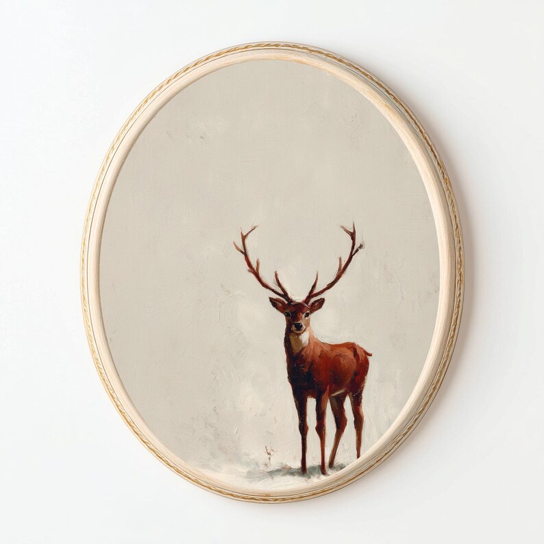 May include: Oval wall mirror with a painted image of a deer with large antlers. The deer is brown and stands against a neutral background. The mirror has a light wood frame with a decorative edge.