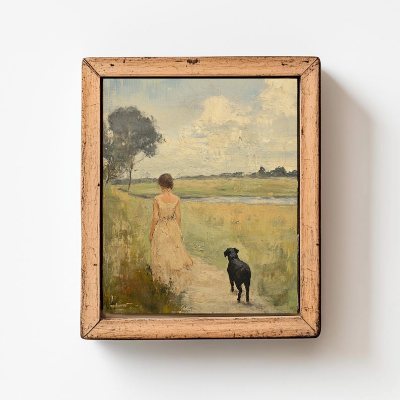 May include: A framed oil painting depicting a woman in a white dress walking with a black dog on a path through a field. The sky is blue with white clouds and there is a small tree in the background.