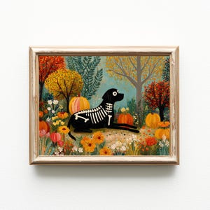 May include: A framed painting depicts a black dog with a skeleton design, lying in a colorful autumn garden. Pumpkins and orange flowers are scattered throughout the scene, with trees in shades of orange and yellow. The artwork has a whimsical, Halloween theme.