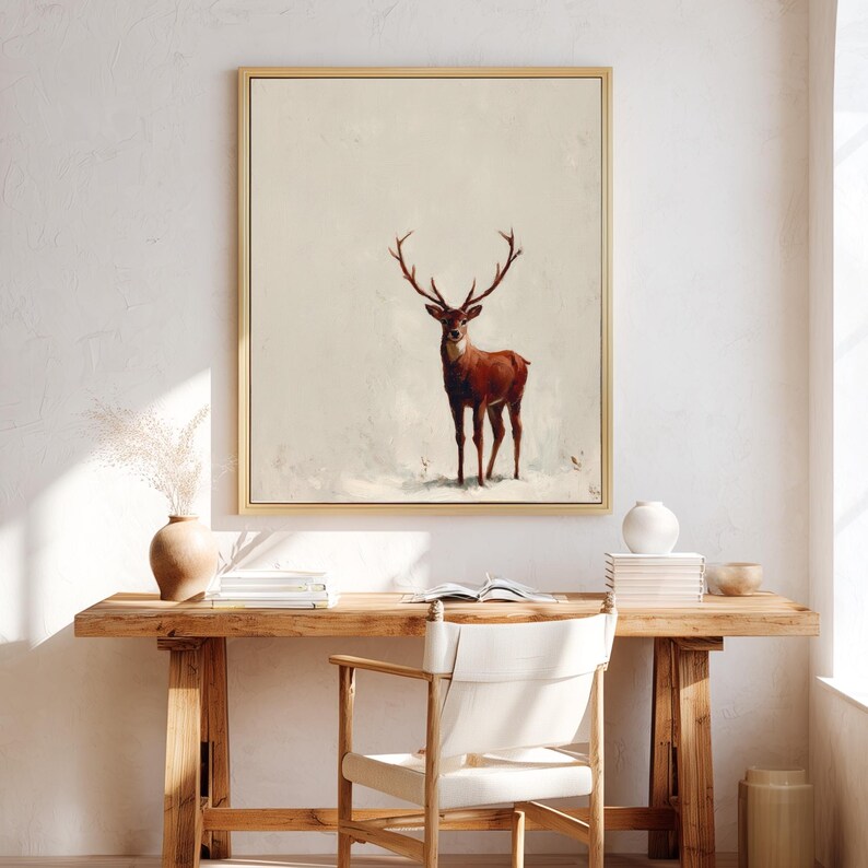 May include: A framed art print featuring a majestic deer with large antlers. The deer is depicted in shades of brown and red against a neutral background. The artwork is encased in a gold-colored frame, suitable for home decor.