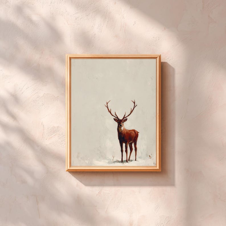 May include: A framed art print featuring a majestic deer with large antlers. The deer is depicted in shades of brown and red against a neutral background. The artwork is encased in a light brown wooden frame, adding a touch of warmth to the piece.