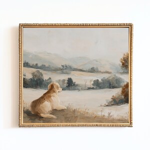May include: A framed landscape painting featuring a golden retriever dog resting in a field, gazing at a distant mountain range. The artwork has a gold ornate frame and a muted color palette of beige, brown, and blue.