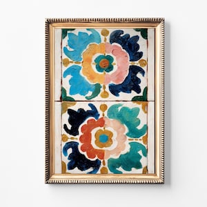 May include: A framed artwork featuring two square panels with floral designs. The flowers are painted in vibrant colors, including blue, orange, pink, and green, set against a white background. The frame is gold-colored.