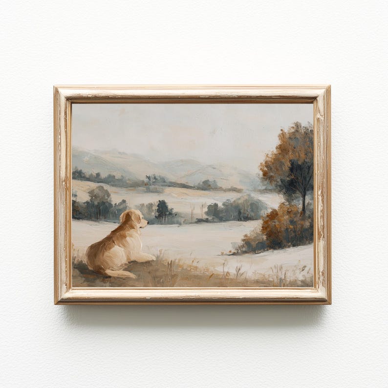 May include: A framed landscape painting featuring a golden retriever dog resting in a field, gazing at a distant mountain range. The artwork has a muted color palette of beige, brown, and blue tones, with a distressed, gold-colored frame.