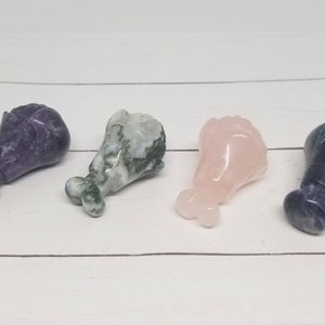 May include: Four carved crystal chicken legs in different colors: purple, green and white, pink, and blue.