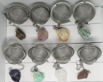 May include: Ten silver tea infusers with chains and various colored crystals attached. The crystals are amethyst, rose quartz, citrine, aventurine, amethyst, amazonite, clear quartz, and red jasper.