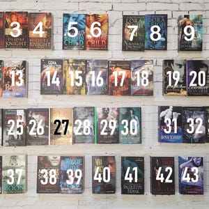 May include: A collection of 45 paperback books with numbers 1 through 45 on the spines. The books are arranged in five rows of nine books each. The books are all different colors and have different titles.