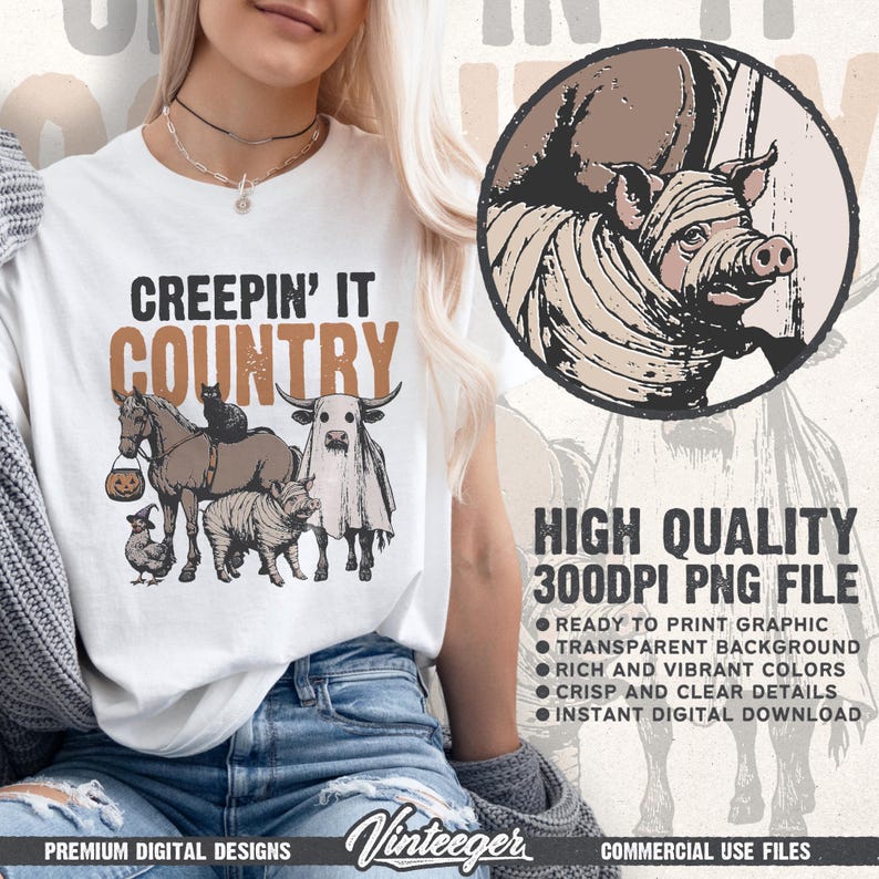 May include: White t-shirt with the text "CREEPIN' IT COUNTRY" in black and brown. The shirt features a graphic of farm animals in Halloween costumes, including a horse, cow, pig, and chicken. A pig in a mummy costume is in a circle.