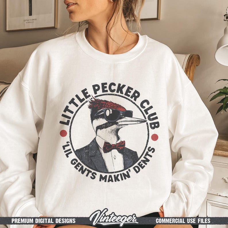May include: White sweatshirt with a circular graphic featuring a woodpecker wearing sunglasses, a suit, and a bow tie. The text reads "Little Pecker Club" and "Lil Gents Makin' Dents". The sweatshirt has a crew neck.