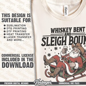 May include: A cream-coloured t-shirt with a graphic of Santa Claus in a cowboy hat, relaxing in a sleigh with a bottle and a glass of whiskey. The text "WHISKEY BENT AND SLEIGH BOUND" is above the Santa illustration. The shirt also includes text about commercial use.
