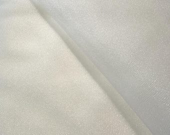 May include: Close-up of white fabric with a subtle sheen. The fabric is folded, creating shadows and highlighting the texture. The material appears soft and lightweight, suitable for various craft projects or apparel.