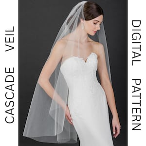 May include: A white bridal veil with a cascade design. The veil is made of soft tulle and has a delicate, flowing look.  DIGITAL PATTERN