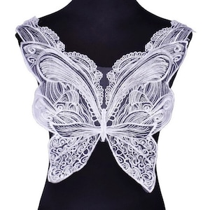 May include: White lace butterfly applique with intricate details. This delicate embellishment is perfect for adding a touch of elegance to clothing, accessories, or home decor projects.