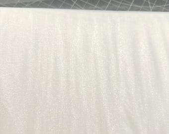 May include: A roll of white tulle fabric, tightly wound and ready for crafting. The fabric is a soft, sheer material, perfect for bridal veils, tutus, or decorative accents. The tulle is a bright, clean white.