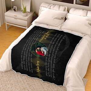 May include: Black and white throw blanket with a gold musical note design. The blanket features a photo of a couple kissing and the text "Your Song" and "10.20.15" in gold lettering.