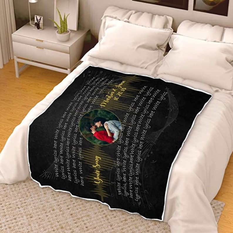 May include: Black and white throw blanket with a gold musical note design. The blanket features a photo of a couple kissing and the text "Your Song" and "10.20.15" in gold lettering.