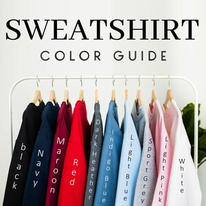 May include: A rack of sweatshirts in various colors, including black, navy, maroon, red, dark heather, indigo blue, light blue, sport grey, light pink, and white.