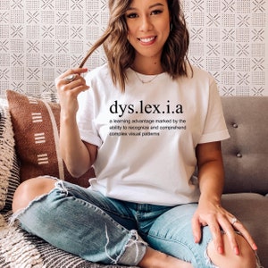 May include: White t-shirt with the text "dys.lex.i.a" and a definition: "a learning advantage marked by the ability to recognise and comprehend complex visual patterns".