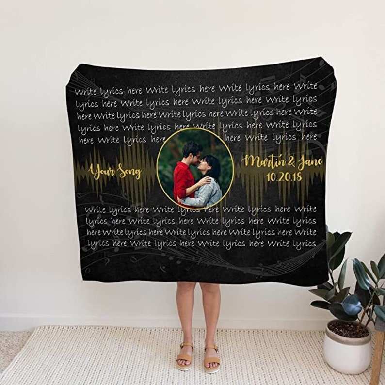 May include: Black and gold personalized blanket with a couple's photo and the text "Your Song" and "Martin & Jane 10.20.18".