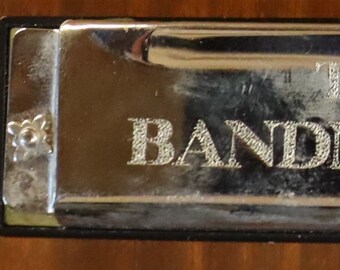 The Bandmaster harmonica 4 inches long 10 holes.