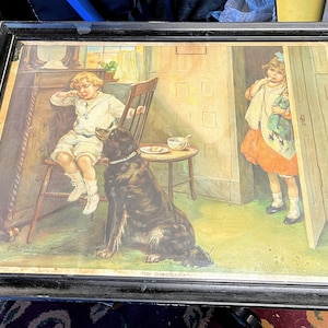 May include: A framed vintage print of a young boy sitting in a chair with a dog beside him. A young girl is peeking out from behind a door. The print is titled "The Little Brother's Plea".