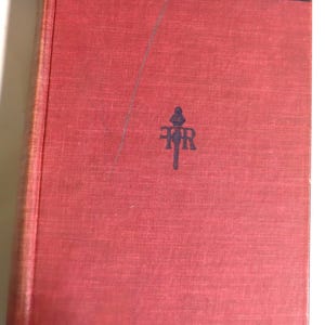 May include: A vintage red book titled "Living Messages" with dark blue text. The book cover features a stylized emblem and the text "Of The Books Of The Bible". The cover has a textured appearance and shows signs of wear.