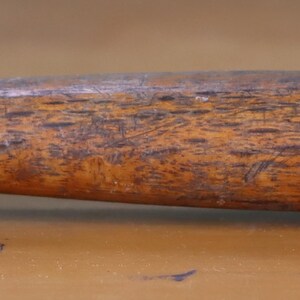 May include: A vintage hammer with a wooden handle. The hammer head is made of metal and has a claw.