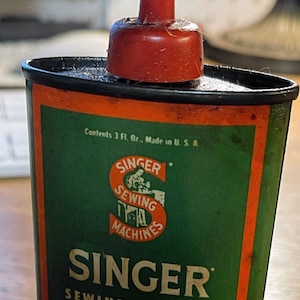 Vintage Singer sewing machine oil can red top