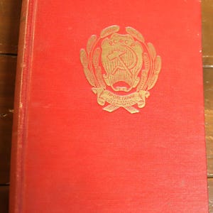 May include: A red book with a gold emblem on the front cover. The emblem features a hammer and sickle inside a wreath with the text "РСФСР" and "ПРОЛЕТАРИИ ВСЕХ СТРАН, СОЕДИНЯЙТЕСЬ!" in Cyrillic.