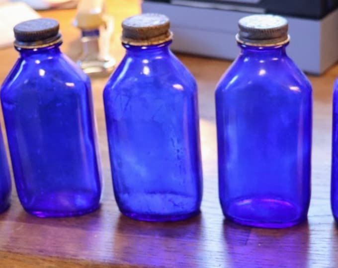 Vintage set of (5)  5 inch tall Phillips cobalt blue bottles with caps
