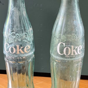 2 vintage Coke bottles 10 oz painted Fl and Miss.