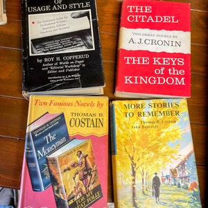 May include: A collection of four vintage hardcover books with colorful covers. The books are titled "A Dictionary of Usage and Style", "The Citadel", "The Keys of the Kingdom", and "More Stories to Remember".