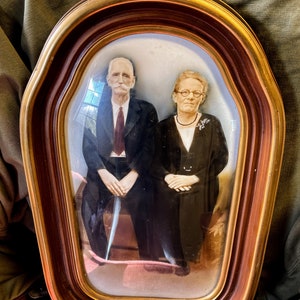 Vintage curved glass picture of older couple.