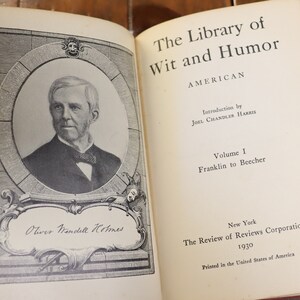 May include: The Library of Wit and Humor, Volume I, by Joel Chandler Harris, featuring a black and white portrait of Oliver Wendell Holmes. The book was published in 1930 by The Review of Reviews Corporation in New York.
