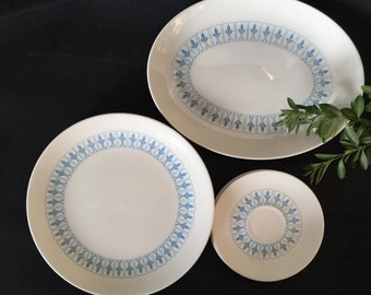 May include: Three white ceramic plates with a blue floral pattern. The plates are in different sizes, with the largest being oval shaped.