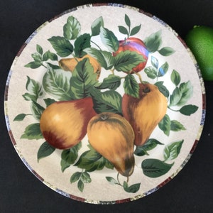 May include: A white ceramic plate with a brown rim features a colorful illustration of pears and apples on a green vine. The plate has a rustic, farmhouse style.