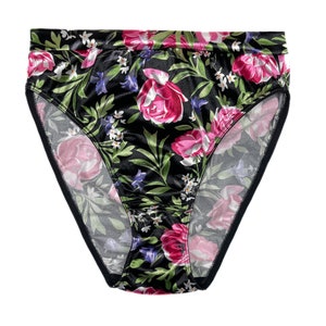 May include: Black satin underwear with a floral print featuring pink, red, and white flowers on a dark green background.