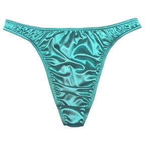 May include: Teal satin thong underwear. The lingerie features a low-rise waist and a ruched detail on the front. The fabric has a shiny, smooth appearance. The background is plain white.