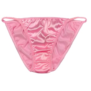 May include: Light pink satin underwear with a low-rise design. The edges are trimmed with a delicate, scalloped detail. The fabric has a shiny, smooth texture, and the garment is designed for comfort and style.