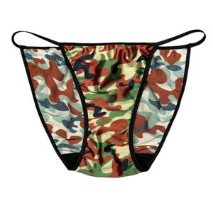 May include: Camouflage-patterned underwear with a black trim. The fabric features a mix of green, brown, and cream colours in a classic camouflage design. The underwear has a string-style design.