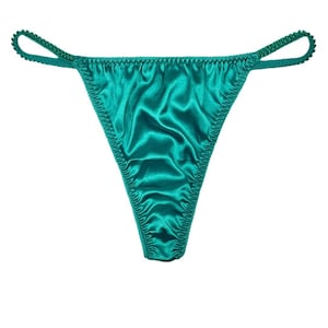 May include: Teal satin thong underwear with a low rise and thin straps.