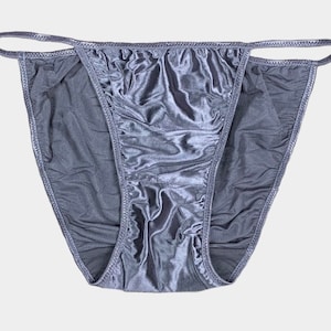 May include: A pair of grey satin underwear with a low rise and a high leg cut.
