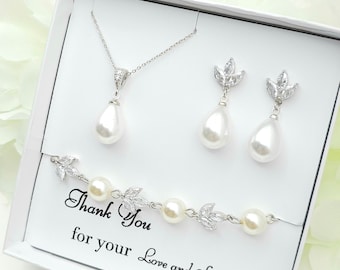 May include: A white jewelry set with a teardrop pearl necklace, earrings, and bracelet. The jewelry features a delicate leaf design with clear rhinestones. The set comes in a white box with the text "Thank You for your Love and Support".