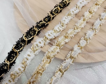 May include: Four different types of gold chain trim with fringe. The trim is black, white, cream, and silver.