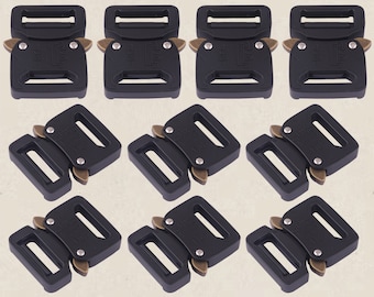 May include: A collection of black metal belt buckles with a matte finish and brass-colored accents. The buckles are rectangular with a secure locking mechanism. The image shows several sets of these buckles, suitable for various applications.