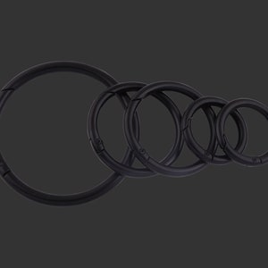 May include: Five black metal key rings of different sizes. The rings are all closed and are arranged in a row from largest to smallest.