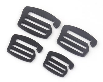 May include: Four black plastic slider buckles, each with three slots. The buckles are commonly used for straps, bags, and other DIY projects.