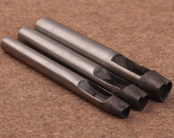 May include: Three metal heart-shaped hole punch tools. The tools are silver and have a rounded handle.