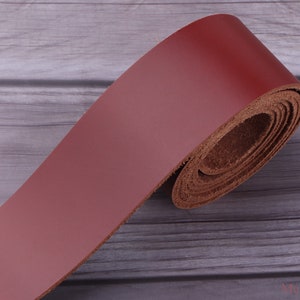 May include: A roll of dark red leather strap, perfect for crafting projects. The leather is smooth and supple, with a natural grain.